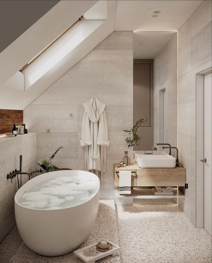 a large white bath tub sitting under a skylight in a bathroom next to a sink