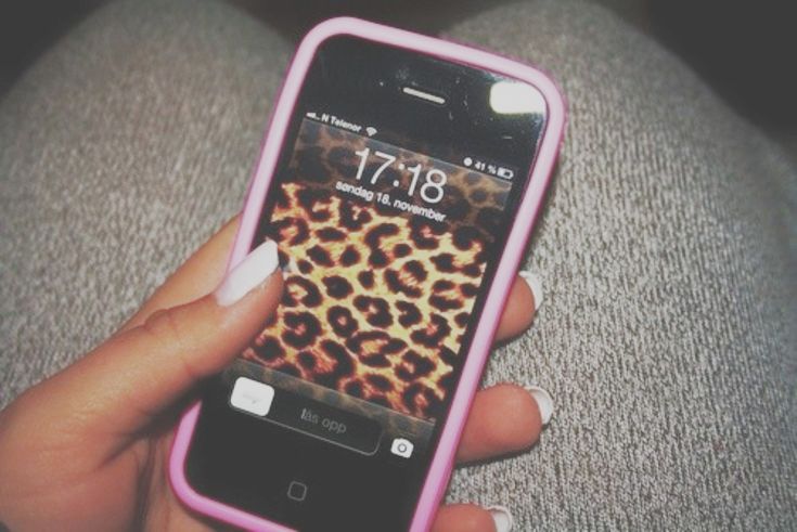 a person holding an iphone in their hand with a leopard print on the back cover