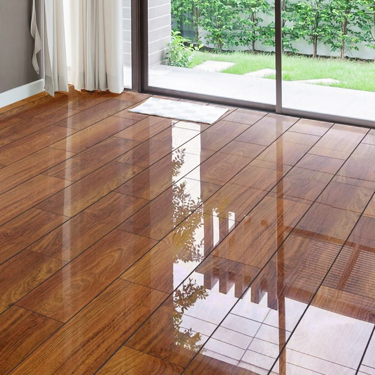 an empty room with wood flooring and sliding glass doors