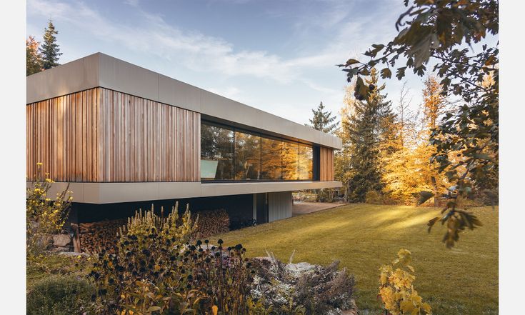 the house is made out of concrete and has wooden sidings on it's sides