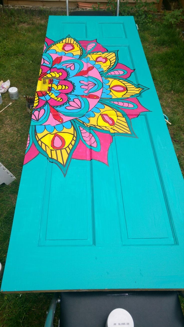 an outdoor table painted with flowers on it