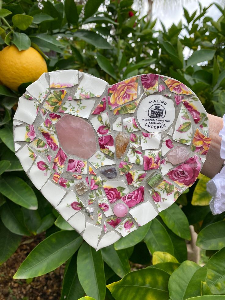 Mosaic heart made with vintage English rose china and accents of rose quartz, amethyst and citrine crystals.  Width: 6.5 inches Height: 6.5 inches The base is a dark grey painted MDF with a small 'D' hook for easy wall mounting.  Due to the nature of the materials, it is not suitable for outdoors. My mosaics may have some sharp edges, so please be careful with them! Mosaic Plant, Garden Mosaics, Decorating Apartment, Princess Life, Mosaic Heart, Amethyst And Citrine, China Rose, Stamp Ideas, Broken China Jewelry