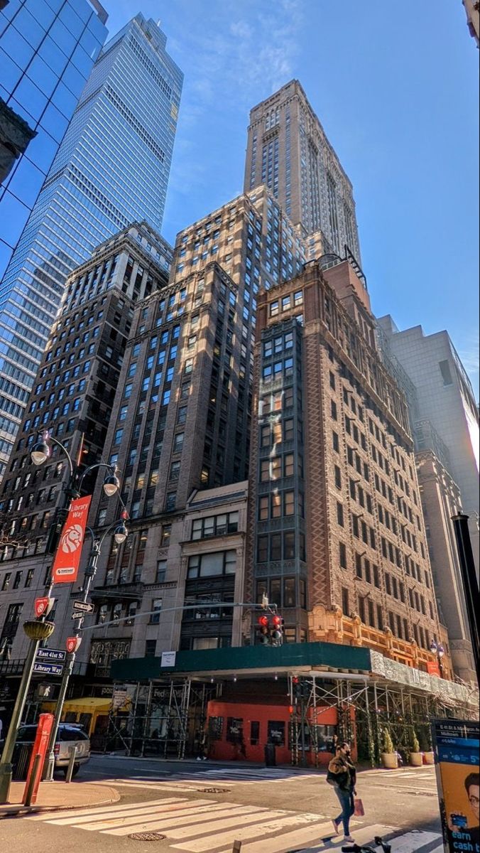 the tall buildings are next to each other on the street corner in new york city