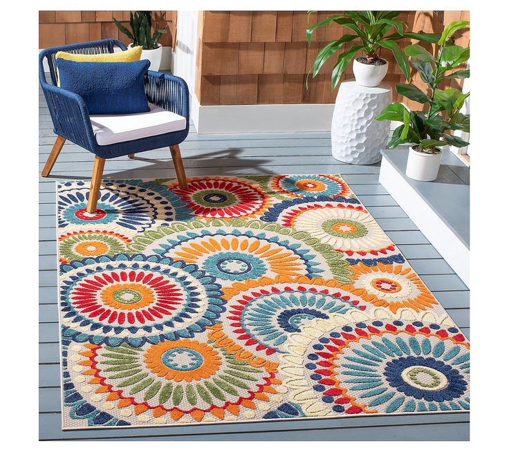 a colorful area rug on a porch with a chair and potted plant in the background