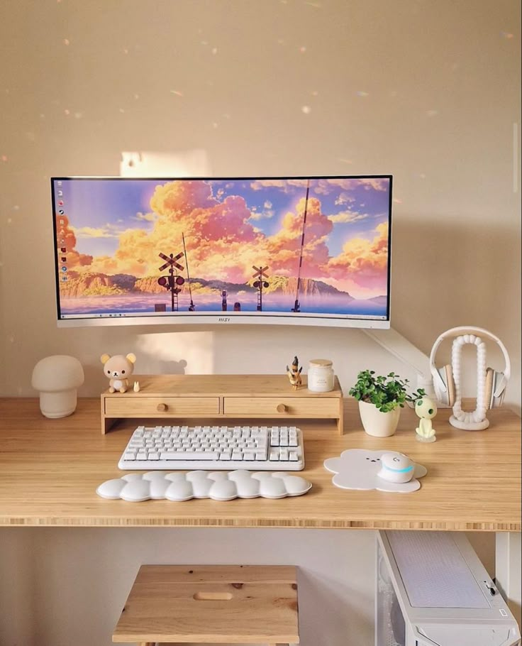 a computer monitor sitting on top of a wooden desk next to a keyboard and mouse