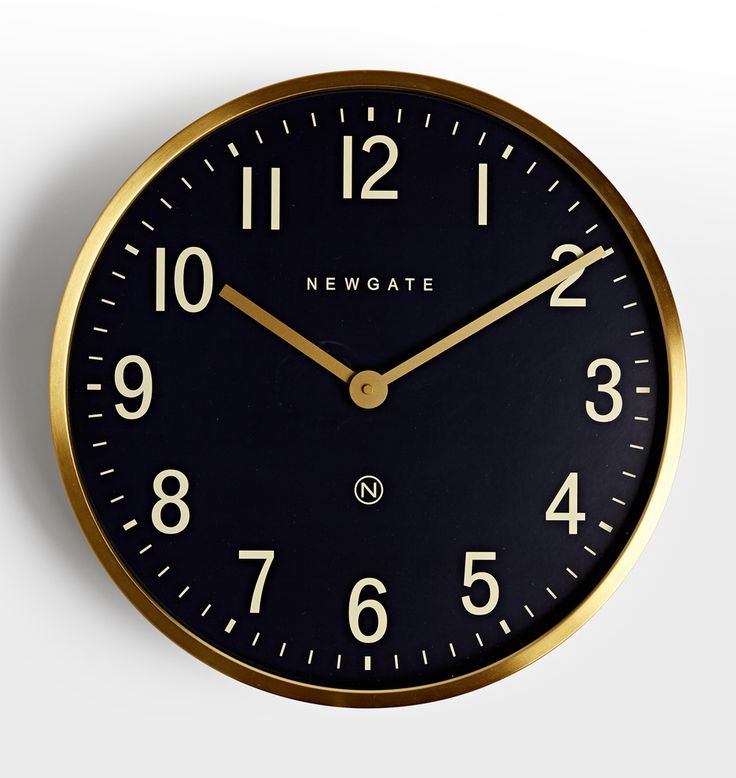 a black and gold clock with numbers on it's face is shown in front of a white background