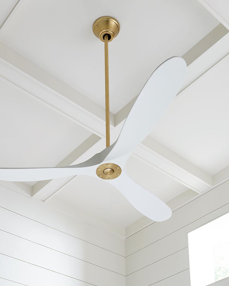 The Maverick 52 in Matte White w Burnished Brass features an 85.0 X 28.0 6-speed motor with a Thirteen-degree blade pitch. With a sleek modern silhouette, a DC motor, and super energy-efficiency, the 52" Maverick ceiling fan features softly rounded blades and elegantly simple housing. Maverick has a 52-inch blade sweep and a 3-blade design that delivers a distinct profile and incredible airflow for living rooms, great rooms, or outdoor covered areas. It includes a hand-held remote with six speed Maverick Ceiling Fan, Brass Ceiling Fan, 60 Inch Ceiling Fans, Propeller Ceiling Fan, Ceiling Fan Bedroom, 52 Inch Ceiling Fan, Ceiling Fans Without Lights, Ceiling Fan Blades, White Ceiling Fan