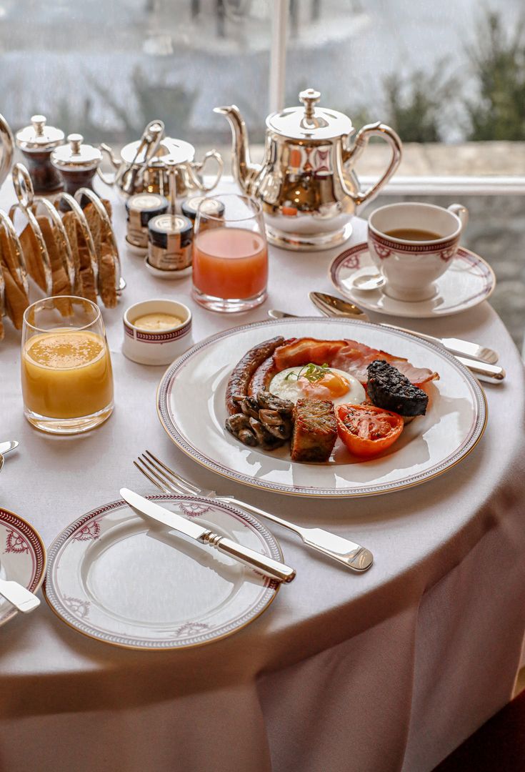 the table is set with breakfast food and drinks