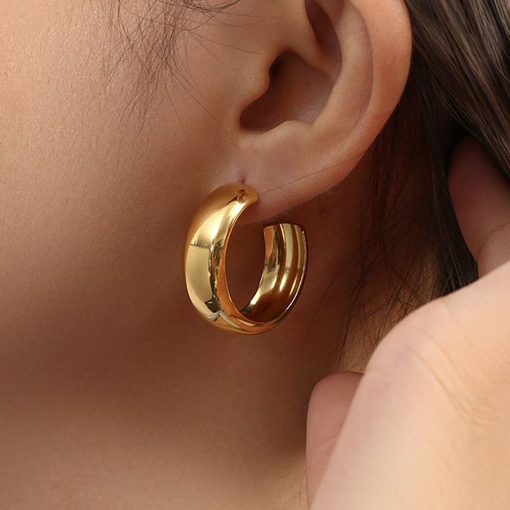 These chunky Bianca Gold Hoop Earrings offer a bold yet stylish statement jewelry look. Crafted from stainless steel and 18k gold-plated for a luxurious finish, each hoop is designed to last, making it an ideal addition to any wardrobe. DETAILS & SIZE Finish: 18k gold plate Material: Stainless Steel Measurements: Diameter; 28mm; Width: 11mm Comes with friction earring backs Waterproof, tarnish-resistant, and nickel free Shop Earrings for more options! Angel Purple, Jewelry Classy, Minimalist Rose, Diamond Engagement Band, Chunky Gold Hoop Earrings, Pink Triangle, Butterfly Bow, Boho Crystal, Platinum Rose Gold