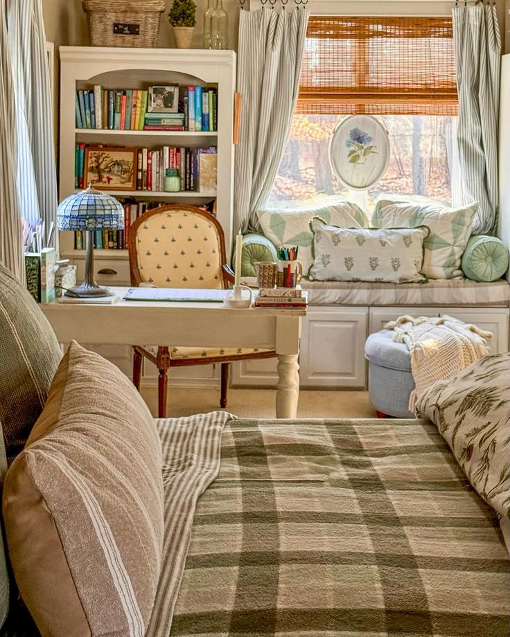 a living room filled with furniture next to a window covered in bookshelves and curtains