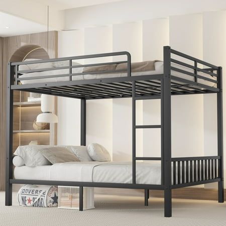 a bunk bed in a room with white walls and flooring, next to a book shelf