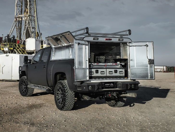 the truck is parked in front of an oil rig