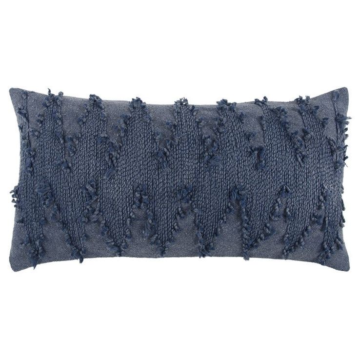 a blue pillow with fraying on the edges and fringed edges, sitting against a white background