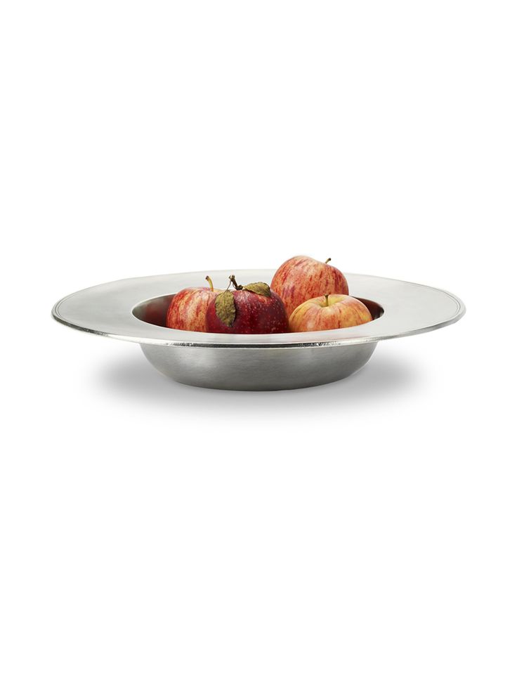 apples in a silver bowl on a white background with clippings to the side