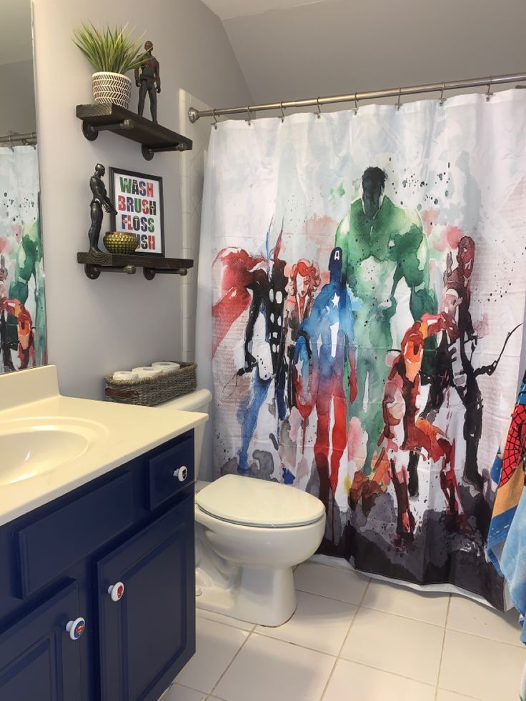 a bathroom with a shower curtain that has an image of the avengers and iron man on it