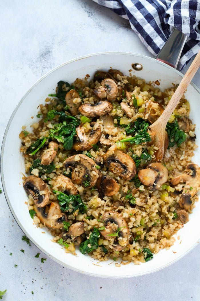 a white bowl filled with rice and mushrooms