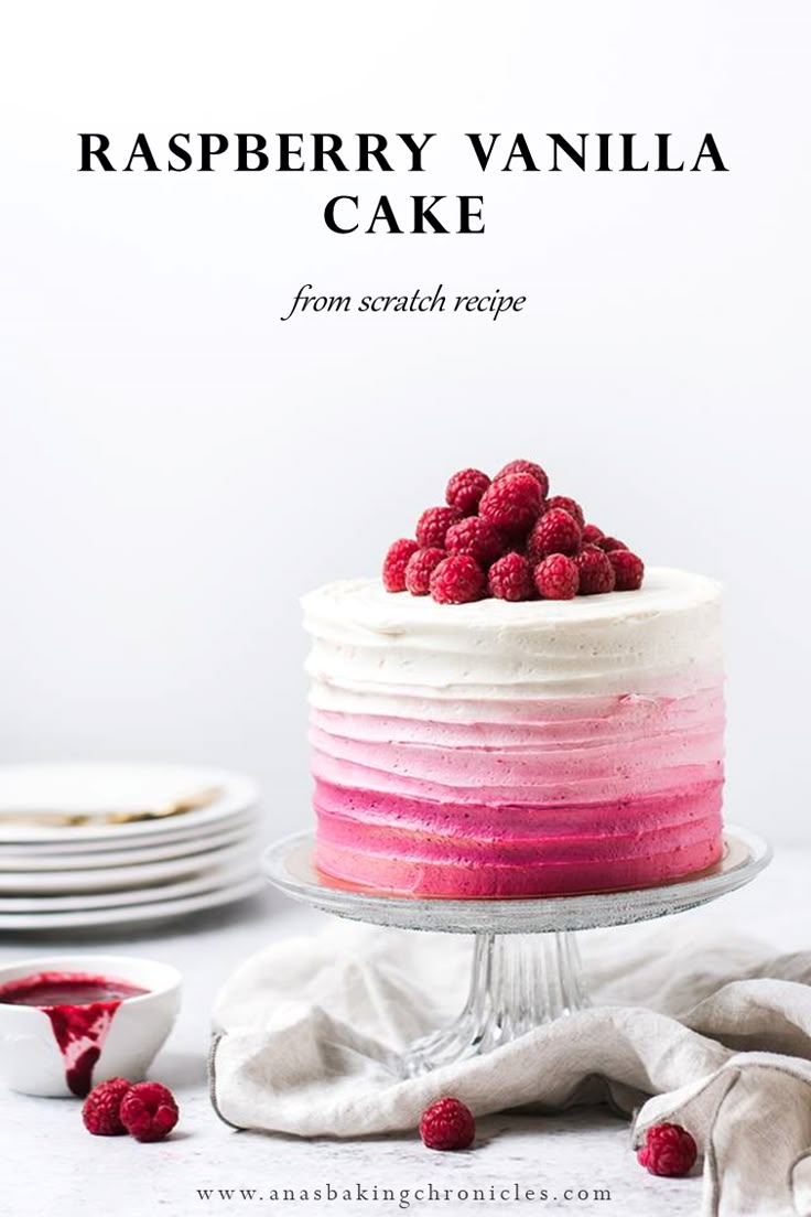 raspberry vanilla cake with white frosting and fresh raspberries on top