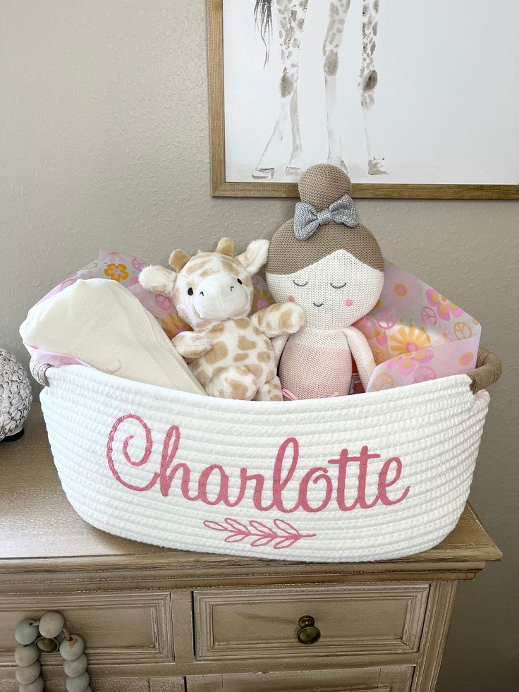 a basket filled with stuffed animals sitting on top of a dresser