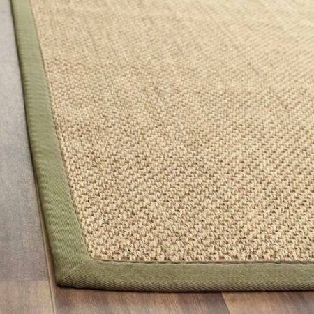 a close up view of a rug on the floor with wood floors in the background