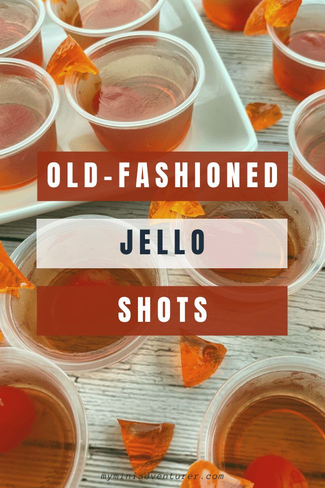 old - fashioned jello shots in plastic cups with orange peels on the side