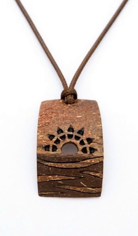 a wooden pendant with an animal's paw on it