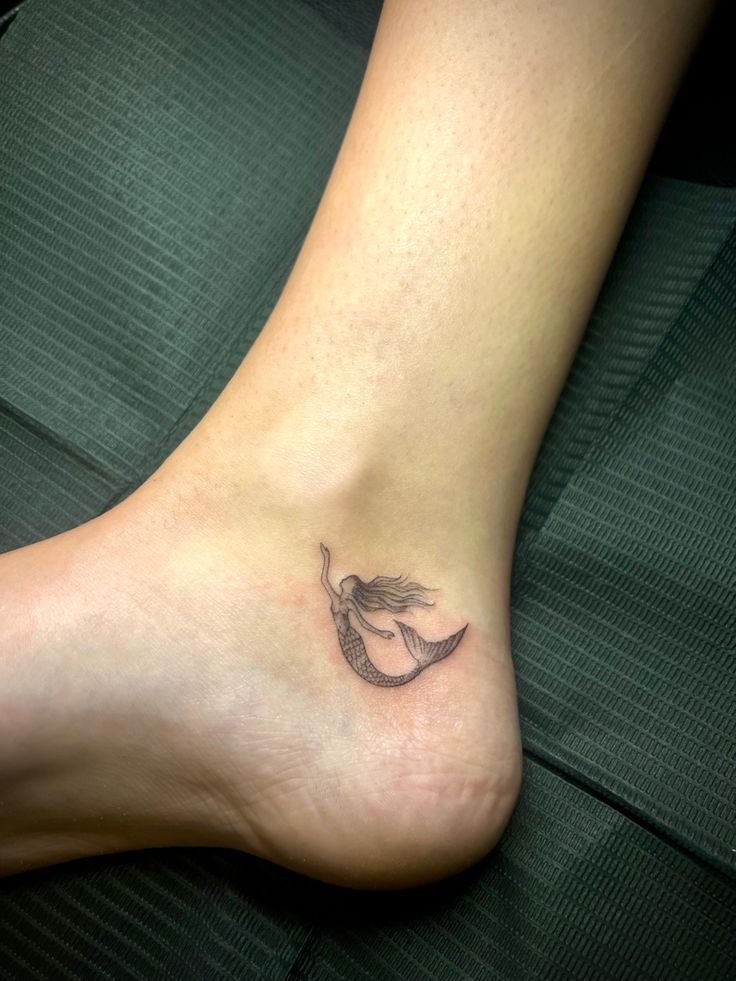 Mermaid Tattoo Minimalist Tiny Tiny Mermaid Tattoo Simple, Mini Mermaid Tattoo, Mermaid Tattoo Minimalist, Dainty Hip Tattoos Women, Simple Mermaid Tattoo, Sea Dragon Tattoo, Mermaid Minimalist, Small Mermaid Tattoo, Water Tattoos