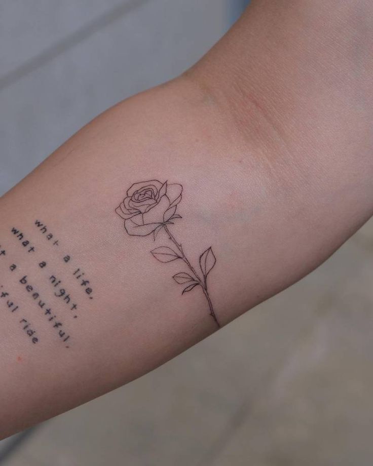 a rose tattoo on the arm with an inspirational poem written in cursive writing