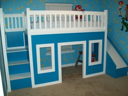 a child's bedroom with blue walls and white bunk beds, stairs to the top