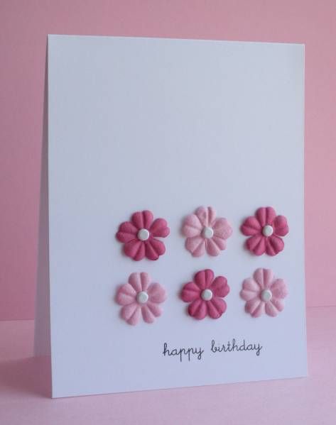 a white card with pink flowers on it and the words happy birthday written in black