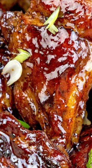 barbecue ribs with bbq sauce and broccoli garnished with onion sprouts