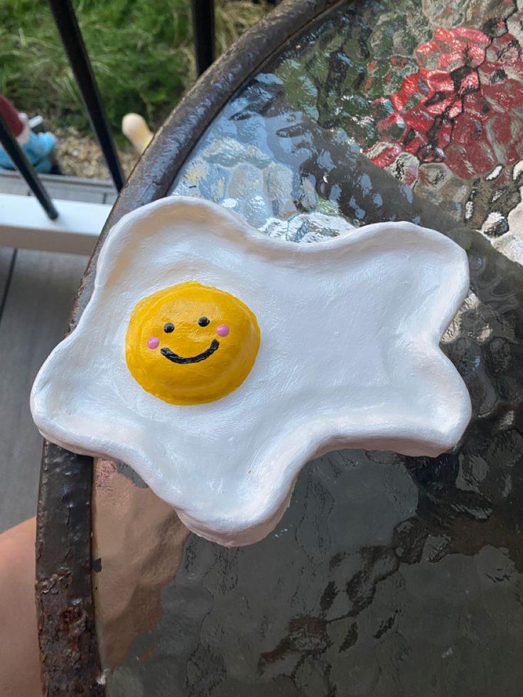 a fried egg with a smiley face painted on it