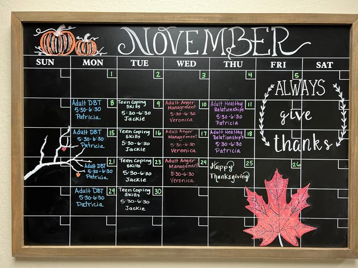 a chalk board with a calendar on it that says november and the month is written out