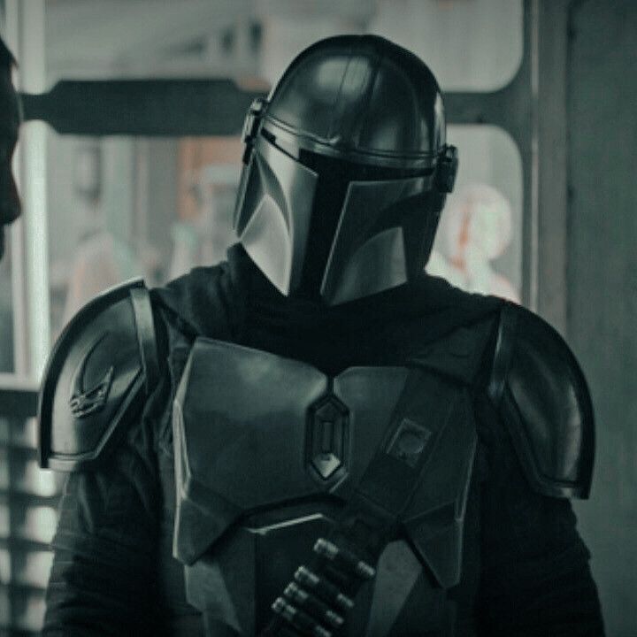 two men in star wars costumes standing next to each other, one wearing a helmet