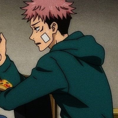 a man with pink hair is eating pizza