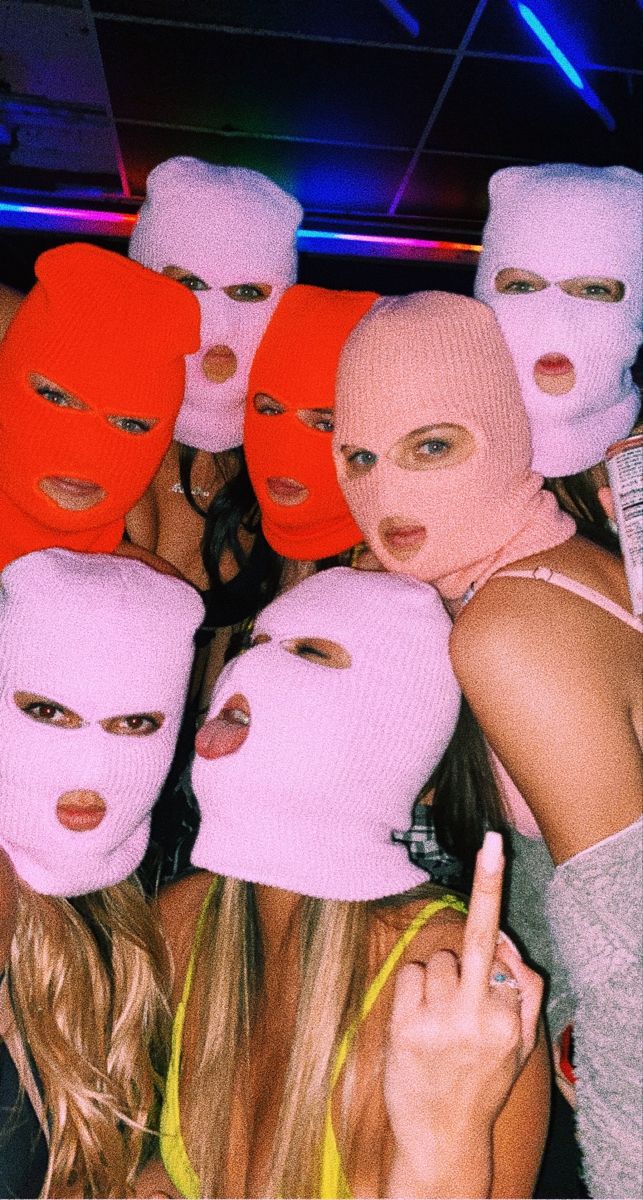 a group of women wearing pink and red masks