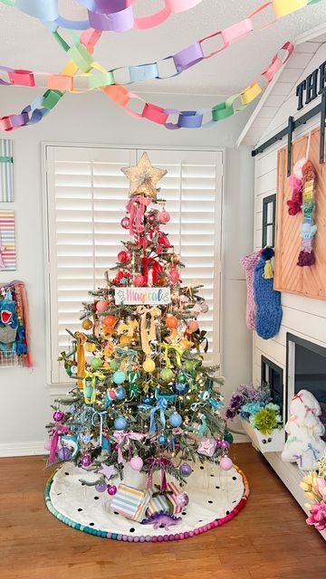 a brightly colored christmas tree in the corner of a room