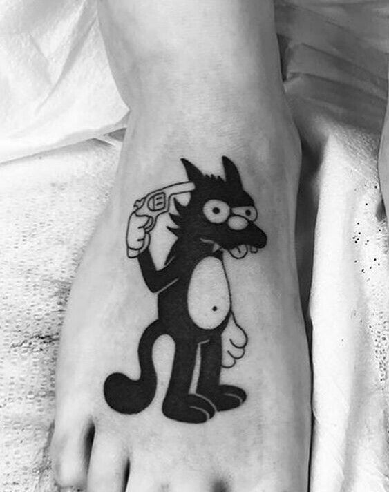 a person with a cat tattoo on their foot