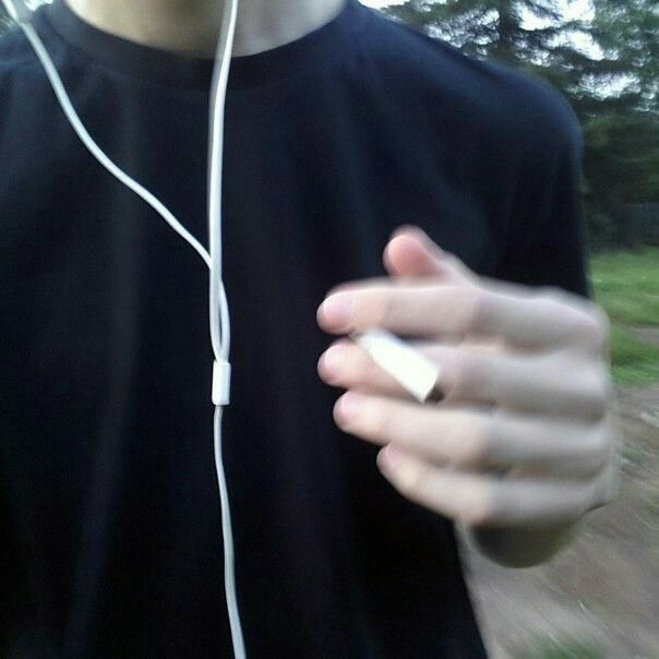 a man wearing headphones and holding something in his hand