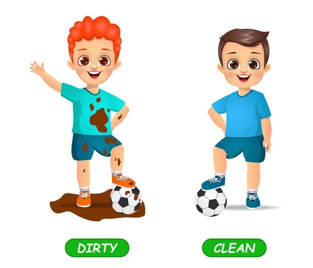 two children are playing with soccer balls and dirt on the ground, one boy is wearing blue