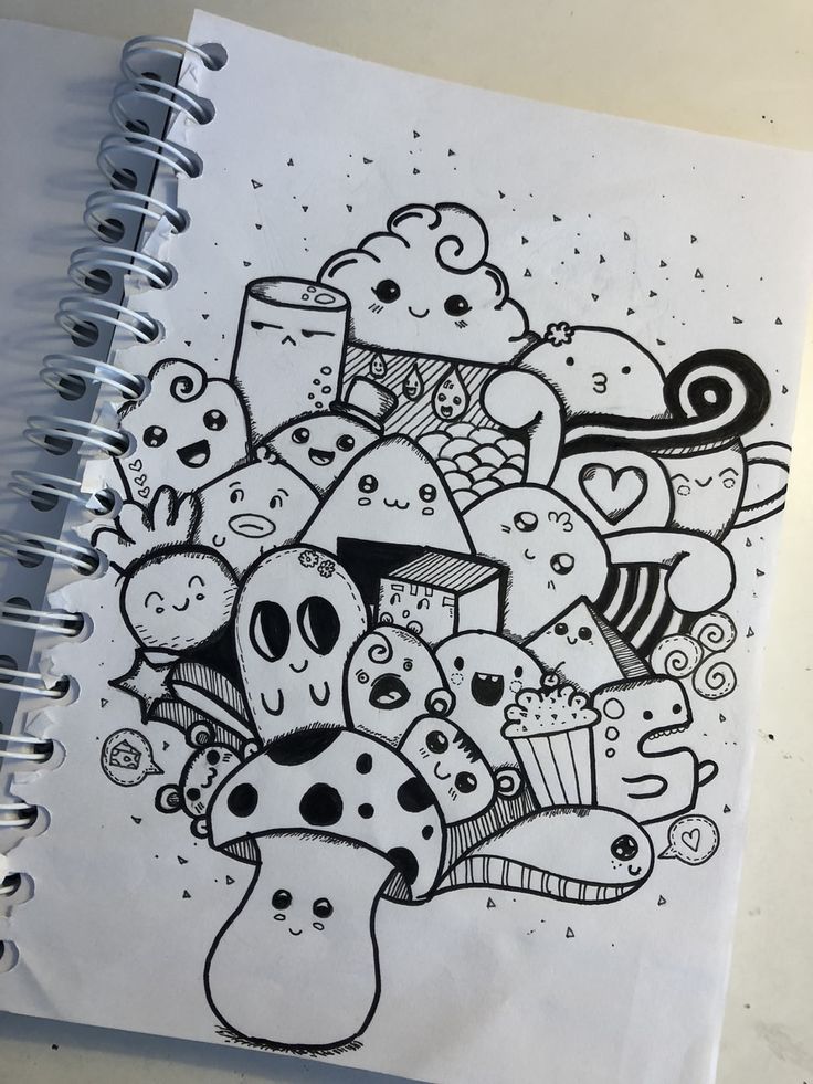 a notebook with some doodles on it and an image of cupcakes in the middle