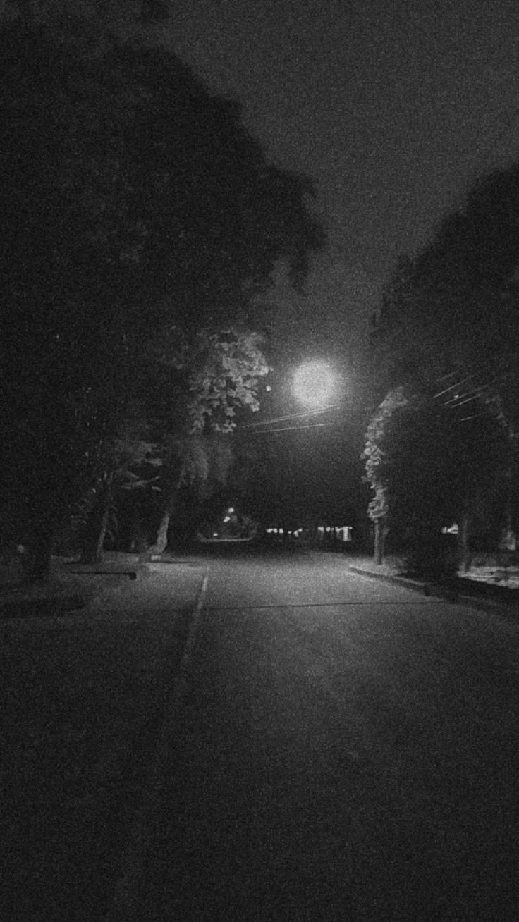 an empty street at night in the dark