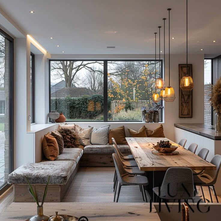 a living room filled with lots of furniture next to a large window covered in windows