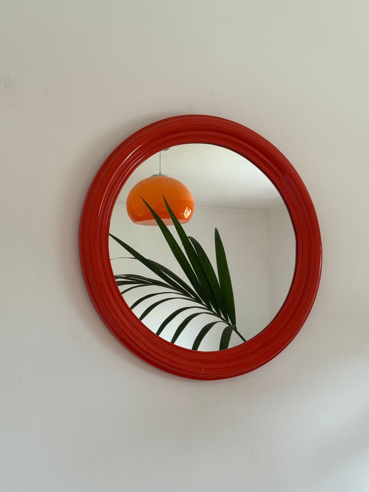 Orange Wooden Round Mirror / Vintage Circle Mirror / Mid Century Modern Wall Mirror / Space Age Mirror / Atomic / Home Decor / Italy / 1970s Step back in time with this Mid Century Modern wall mirror inspired by the chic aesthetics of 1970s Italy. This vintage circle mirror, crafted with a vibrant orange wooden frame, brings a touch of retro charm to any space. Perfect for adding a pop of color and style to your home decor, this round mirror is a unique piece that effortlessly merges vintage all Wooden Round Mirror, Mirror Mid Century Modern, 70s Mirror, Mirror Space, Circle Mirrors, 1970s Italy, Mirror Mid Century, Aged Mirror, Circle Mirror