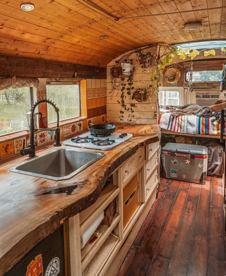 a kitchen area with sink, stove and oven