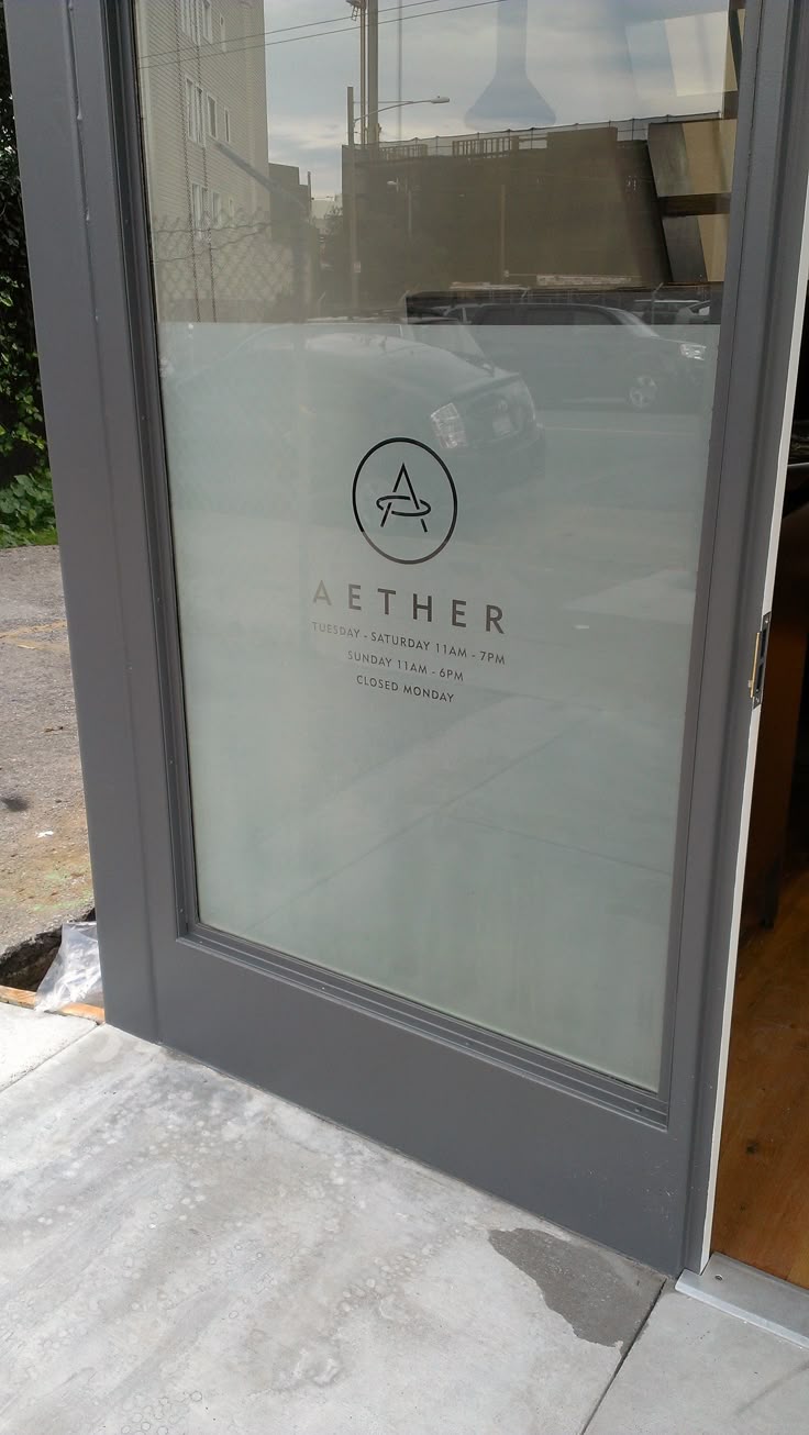 an open door with the word aether written on it in front of a building