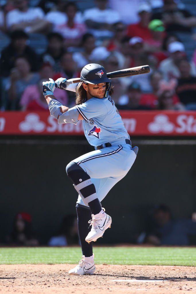 a baseball player is getting ready to swing at the ball in front of an audience