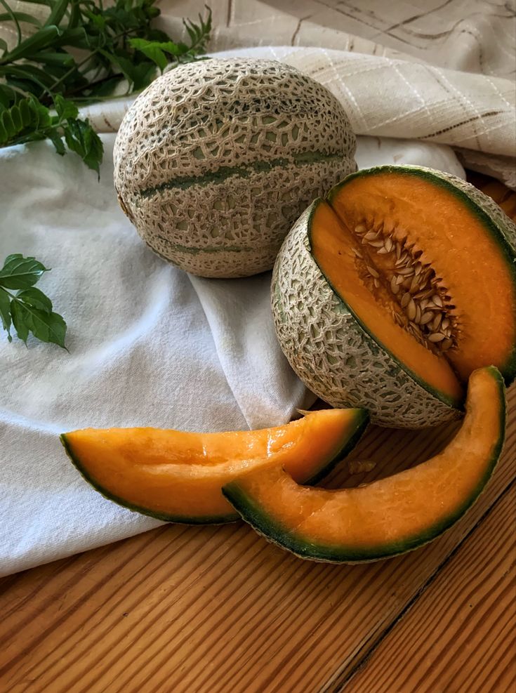 two melons cut in half on a table