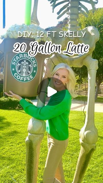 a woman standing in front of a fake skeleton holding a coffee cup with the caption 20 gallon late