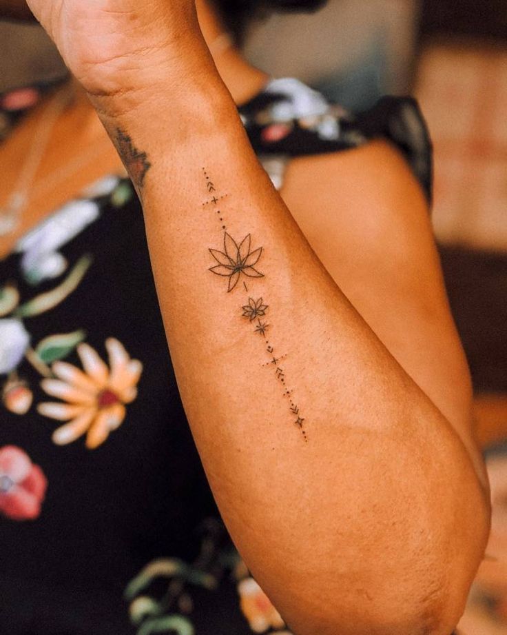 a woman with a flower tattoo on her arm