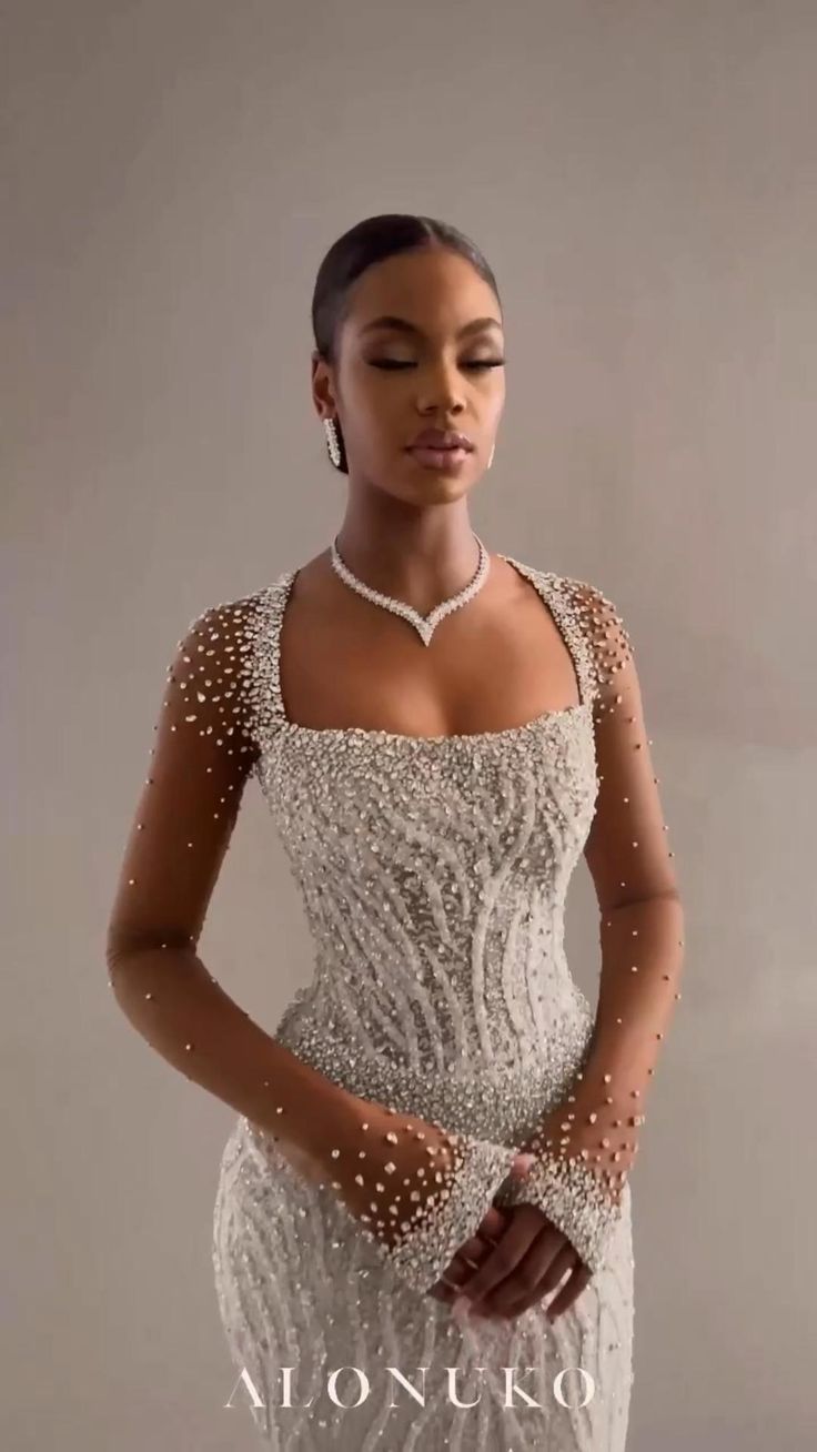 a woman in a white dress with pearls on it